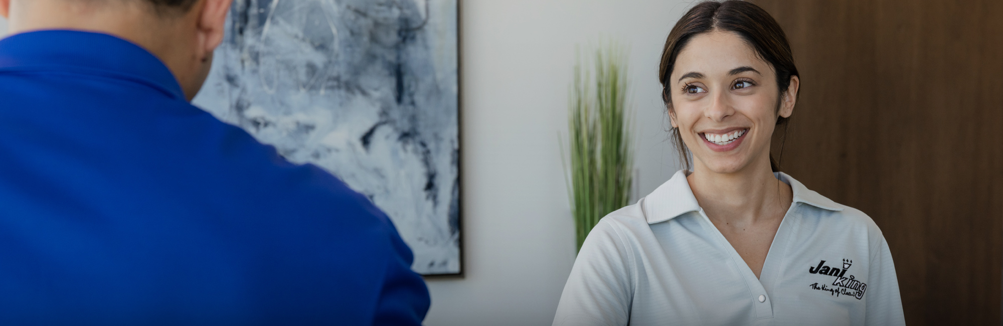 a woman is smiling and talking to a man