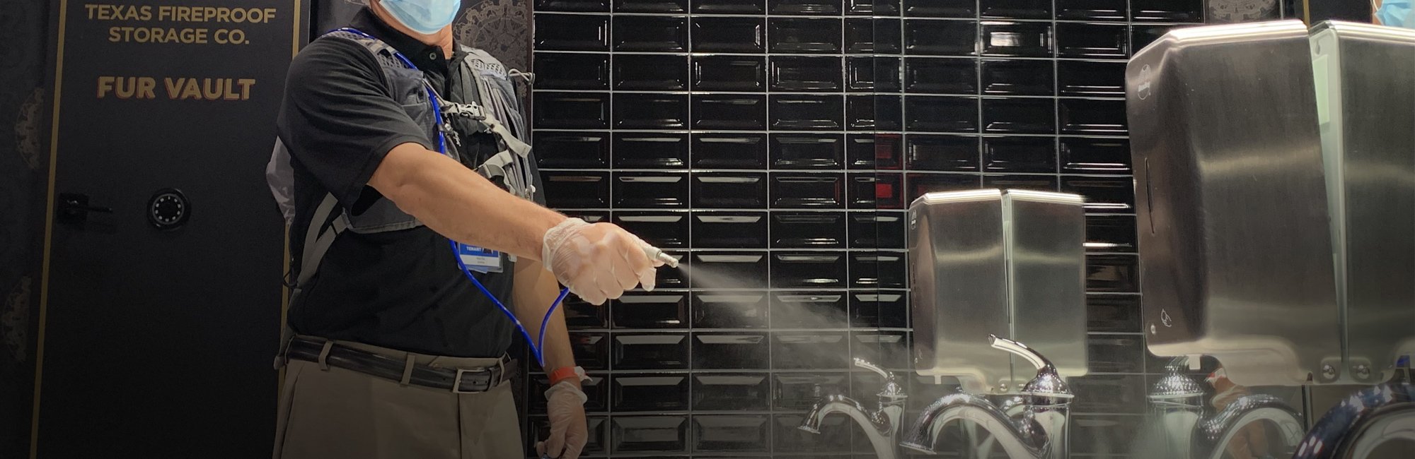 a man in a mask sprays a metal structure