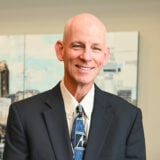 a man in a suit and tie smiling