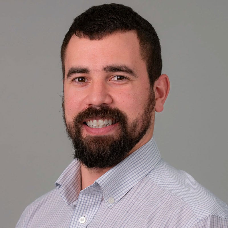 a man with a beard and a blue shirt