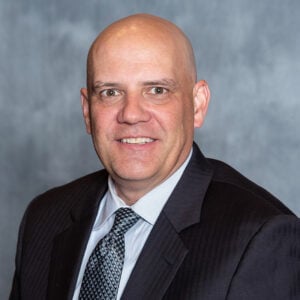 a man in a suit and tie smiling