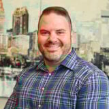 a man in a blue shirt and plaid shirt