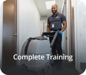 a man in a blue shirt and black pants is cleaning a room with a carpet cleaner